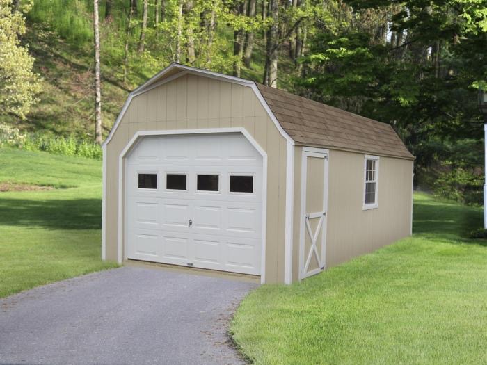Tan Dutch barn style garage with a roll-up door.