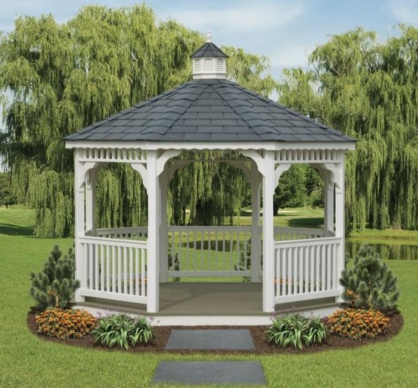 White vinyl octagon gazebo with a cupola, framed by weeping willow trees.