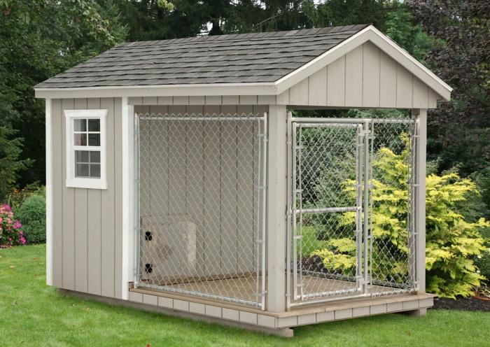 Wood-sided dog kennel with a chain-link run.