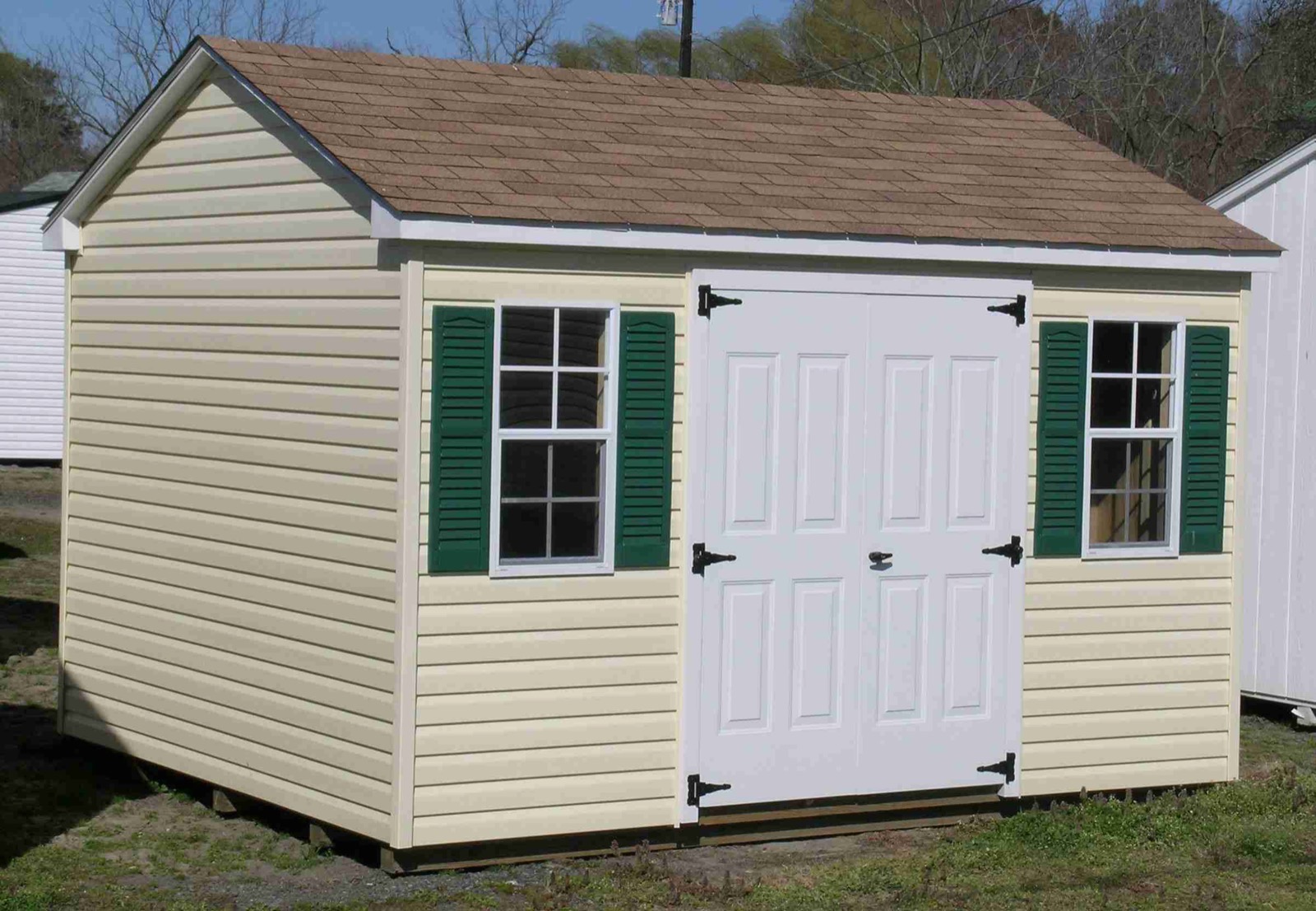 Grey wood A-frame shed with white double doors, built by MD Sheds & Gazebos.