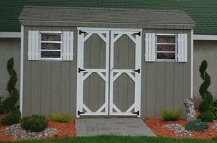 Small grey wood A-frame storage shed on display.